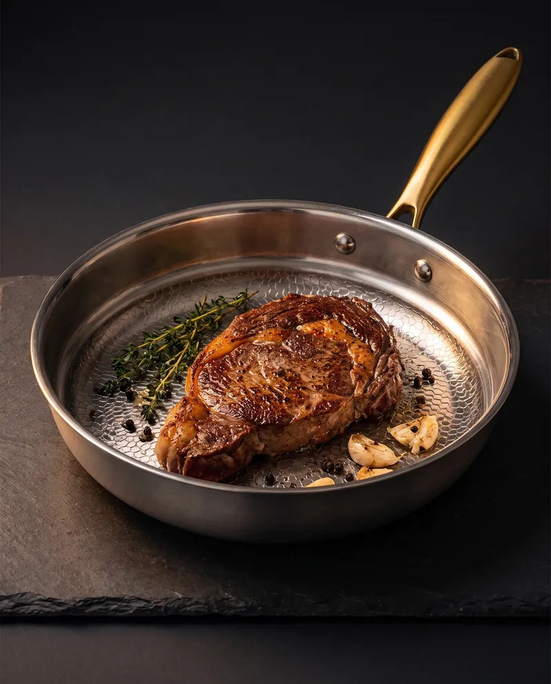 La poêle en titane sans PFAS avec un steak saisi sur une ardoise sombre